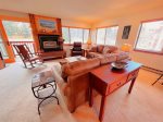 Inviting Living Room with gas fireplace, lots of sunshine and cozy seating for all